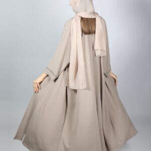 Woman wearing a beige crepe abaya - Everyday Crepe Abaya in warm sand