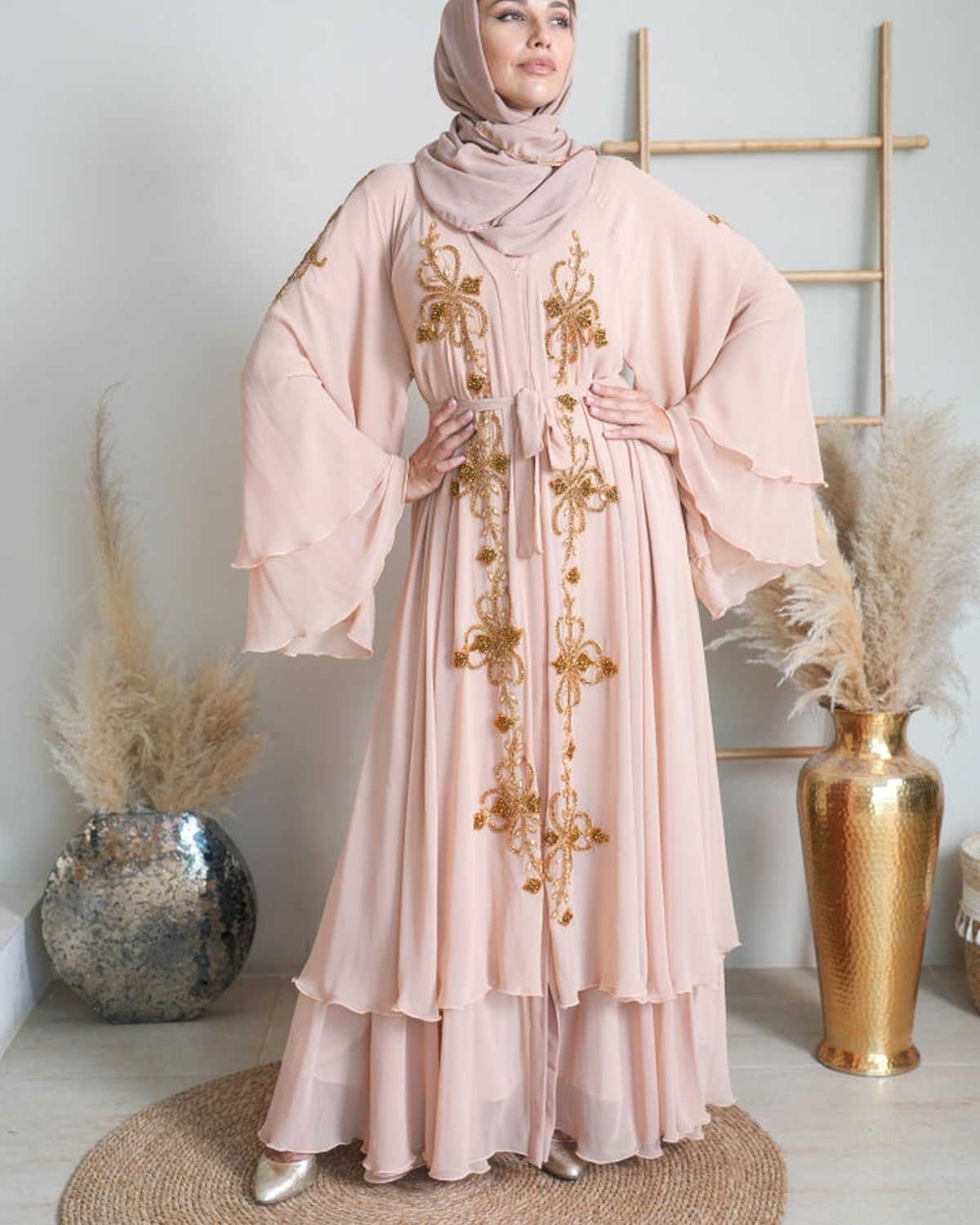 Woman in a rose pink embroidered abaya with beige headscarf - Eid Edit Embellished Abaya in rose taupe